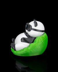 Side view of a panda figurine leaning back in a bright green chair with goggles around its head.