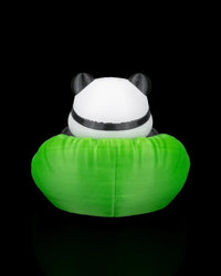 Rear view of a panda figurine seated in a bright green chair with black ears visible above the backrest.