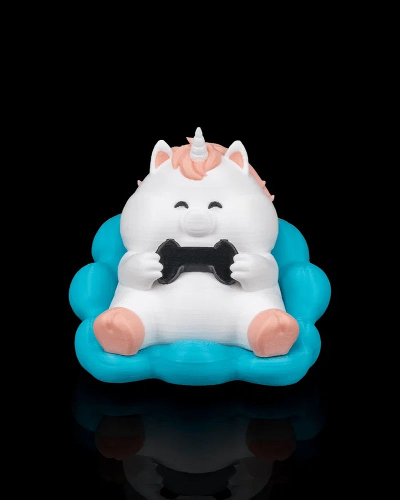 Front view of a white unicorn figure with a pink mane holding a black controller on a turquoise cloud seat.