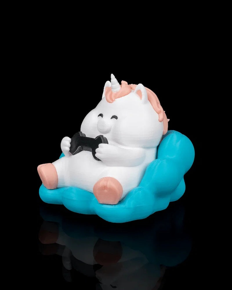 Angled front view of a white unicorn figure seated on a turquoise cloud seat and holding a black controller.