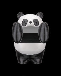 Front view of a black-and-white panda figurine with raised paws on a black background