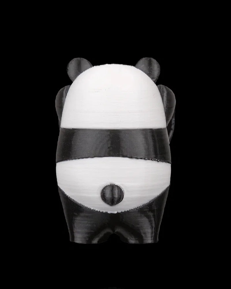 Back view of a black-and-white panda figurine with small tail on a black background