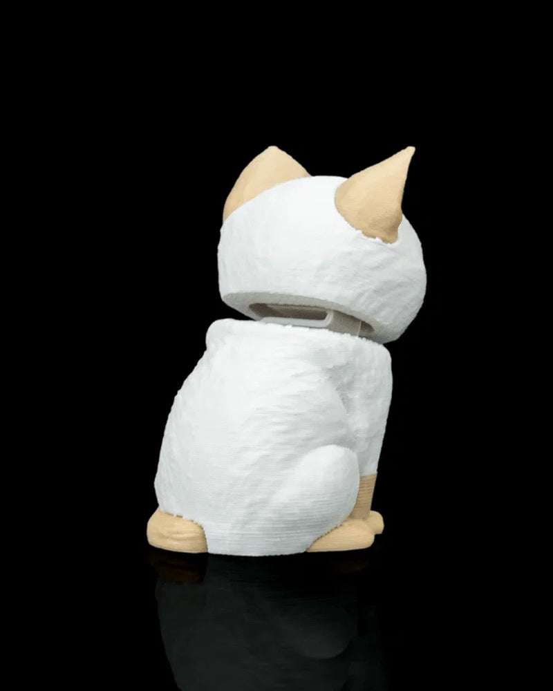 Rear angled view of a cream and white cat figure with tan ears and tail on a black background