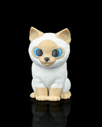 Front view of a seated cream and white Siamese cat figure with blue eyes on a black background