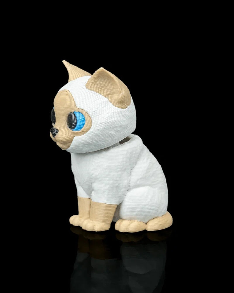 Side view of a seated cream and white Siamese cat figure with blue eyes on a black background