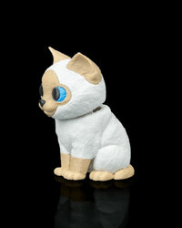 Side view of a seated cream and white Siamese cat figure with blue eyes on a black background