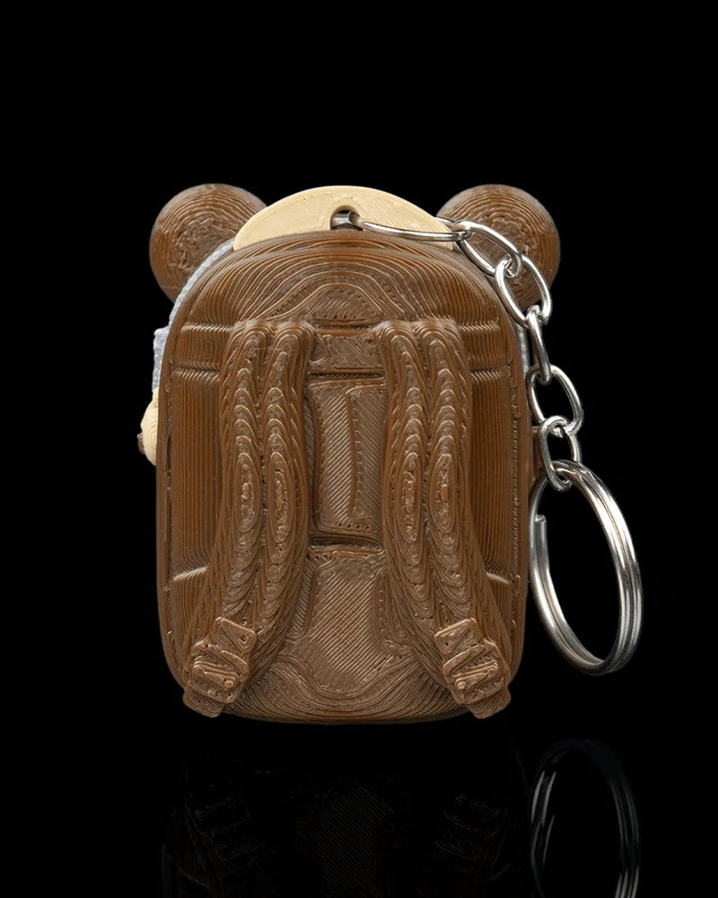 Back view of a brown pack-shaped case with raised strap details and a metal ring and chain at the side