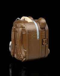 Rear angled view of a brown pack-shaped case with raised strap details and a pale zipper-like detail