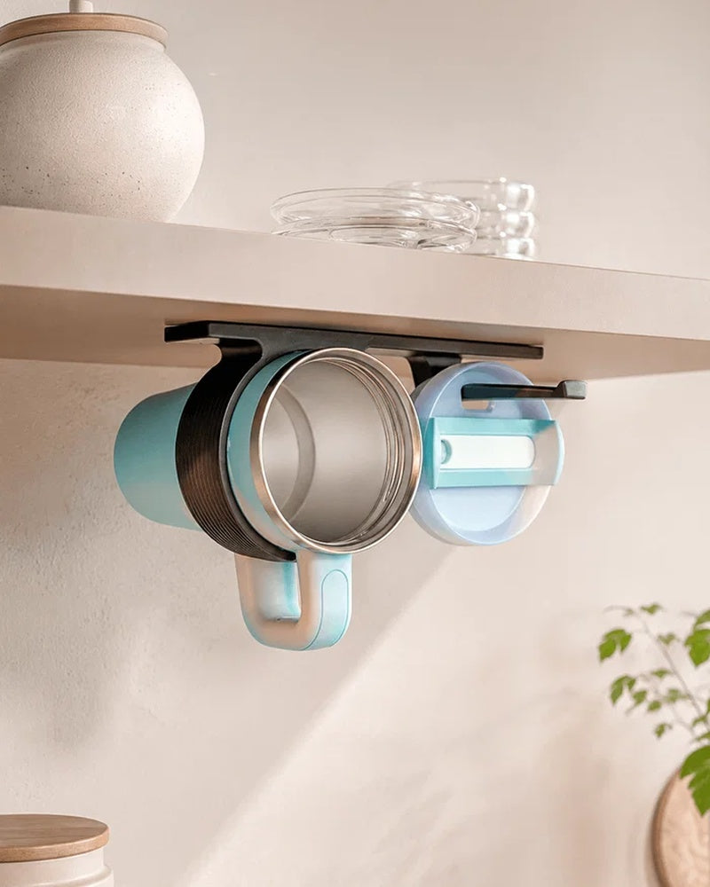 Under-shelf rail organizer holding a mug and round lid beneath a shelf