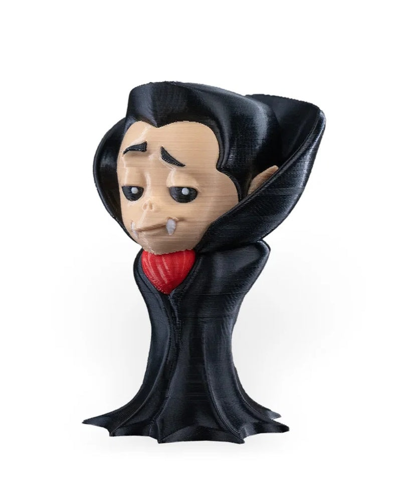 Angled front view of a small monster figure with sleepy eyes, pointed ears, black collar, and red front accent on a white background.