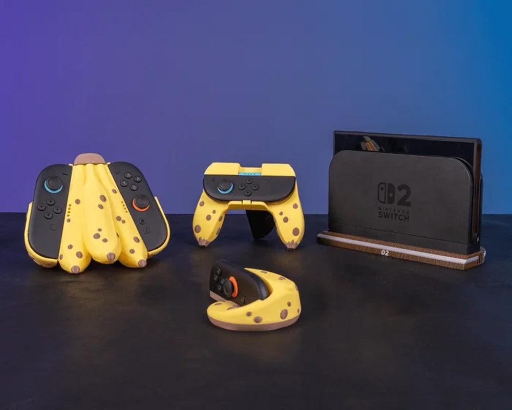 Gaming accessories on a dark tabletop, including a console dock on a wood-tone base and yellow controller covers