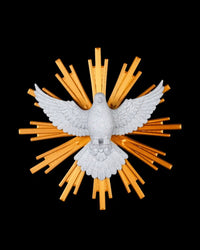 White dove figurine with outstretched wings in front of golden rays on a black background