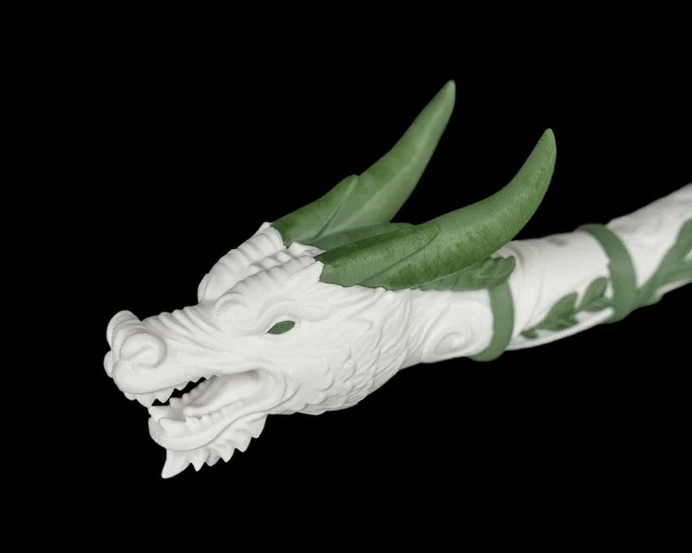 Close-up of a white dragon head with green horns and an open mouth