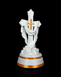 Front view of a white speckled draped cross statue with a gold-tone cross accent and gold-tone base trim.