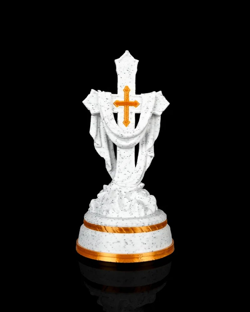 Front view of a white speckled draped cross statue with a gold-tone cross accent and gold-tone base trim.