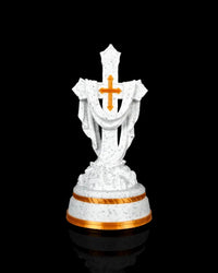 Front view of a white speckled draped cross statue with a gold-tone cross accent and gold-tone base trim.