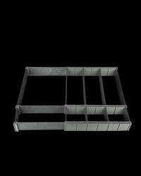 Black rectangular drawer organizer with multiple long compartments on a dark background