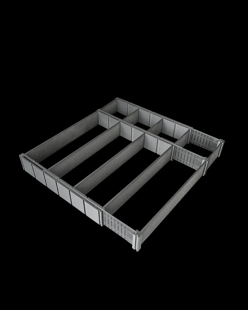 Black drawer organizer viewed at an angle with several divided sections