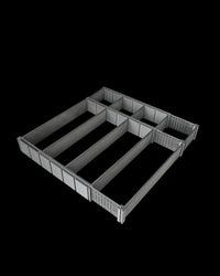 Black drawer organizer viewed at an angle with several divided sections