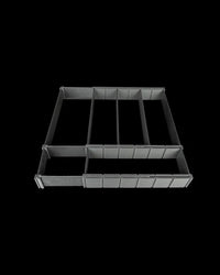 Black partitioned drawer organizer with long open compartments on a dark background