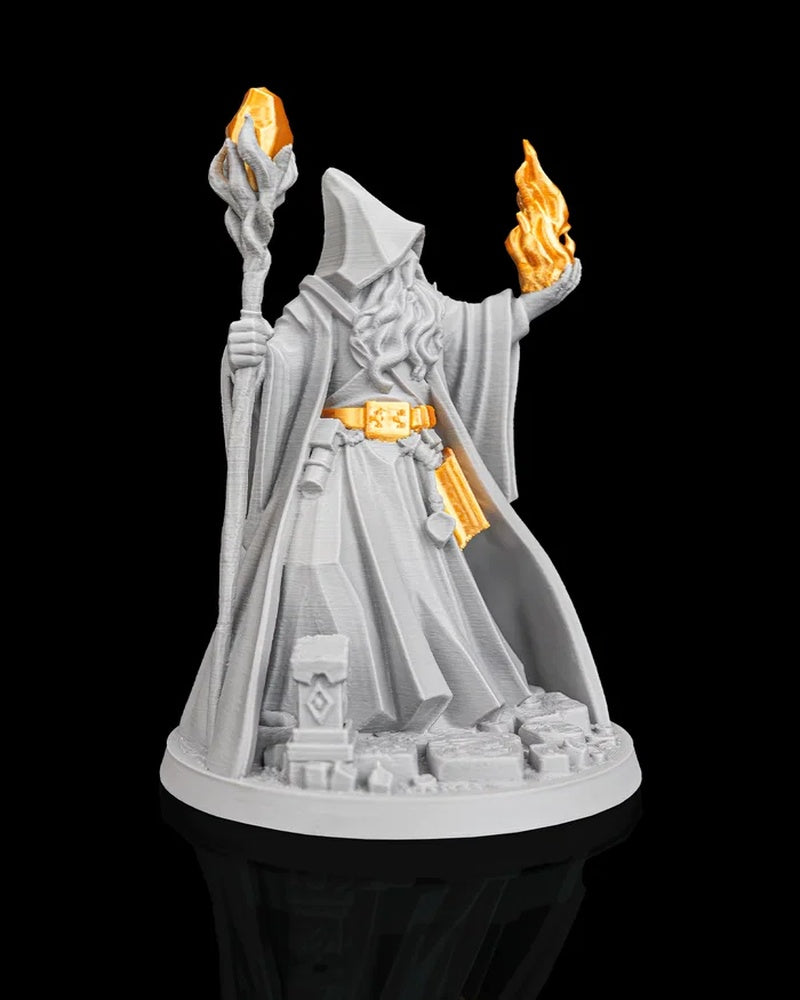 Front angled view of a robed wizard figurine with orange accents on the belt, book, flame, and staff crystal