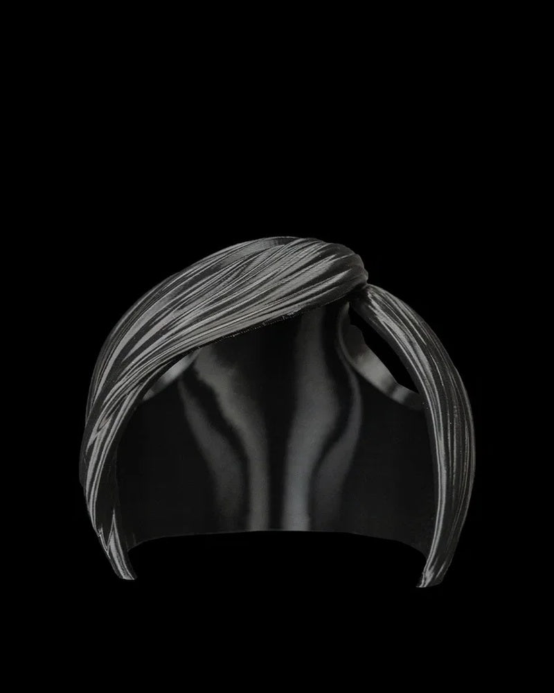 Black side-swept bangs piece shown from the front on a black background.