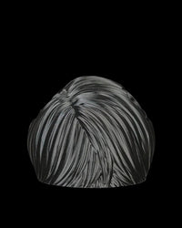 Black bangs piece shown from the back on a black background.