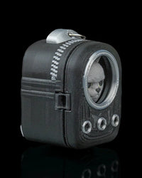 Angled side view of a dark backpack-shaped cat figure with a round front window and top ring