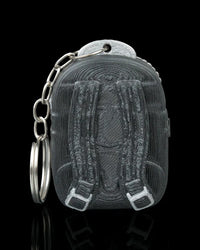 Back view of a dark backpack-shaped figure with strap details and a metal ring and chain