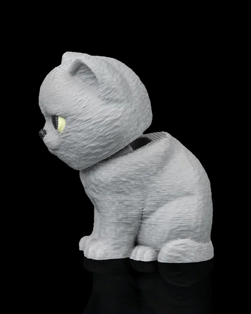 Side view of a seated grey cat facing left with yellow eye visible