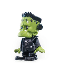 Side view of a green monster figurine showing a large brow, black eye, neck bolt, black clothing, and textured surface lines.