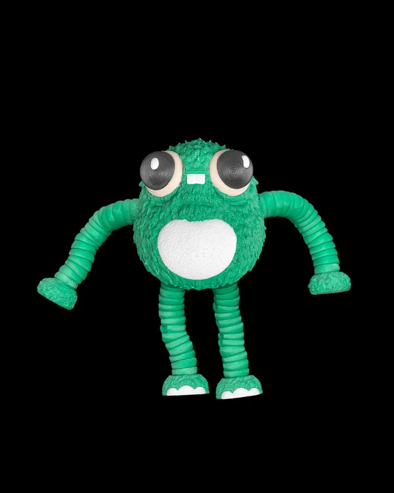 Green frog fidget with large black eyes, a white belly, and long segmented arms on a black background