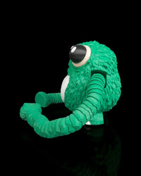 Side view of a green frog fidget with large eyes, a white belly, and curled segmented arms