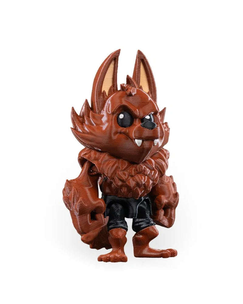 Angled front view of a reddish-brown monster figurine with tall ears, black eyes, fangs, and dark lower-body detail.