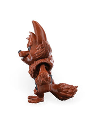 Side view of a reddish-brown monster figurine with tall ears, pointed snout, large hand, and textured tail.