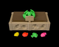 Tan garden bed tray with raised vegetable shapes, small sign, green sprout shape, and four bright colored lumps in front.
