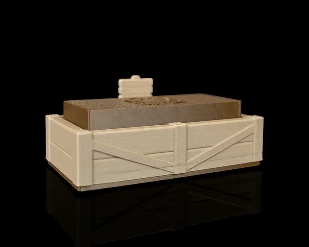 Angled view of a tan garden bed tray with a brown insert and small sign on a black background.
