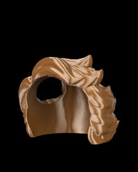 Brown wave-styled headpiece shown from the side on a black background.