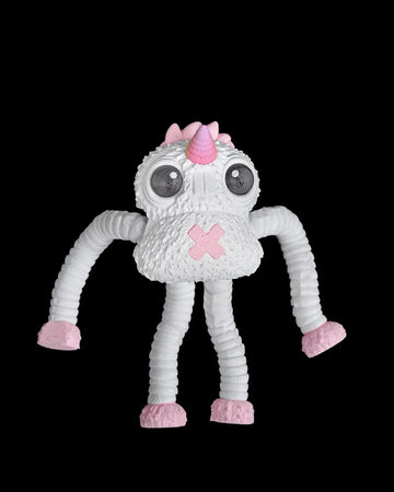 White monster figurine with large dark eyes, a pink horn, pink feet and long ribbed arms on a black background