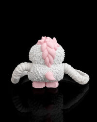 Back view of a white monster figurine with pink back spikes, a pink tail and ribbed arms on a black background