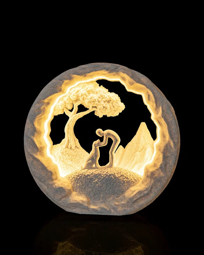 Glowing round lamp with a dog, tree, and mountain shapes inside a textured circular frame