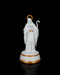 Front view of a white shepherd statue with gold halo, staff, and gold-accented round base against a black background.
