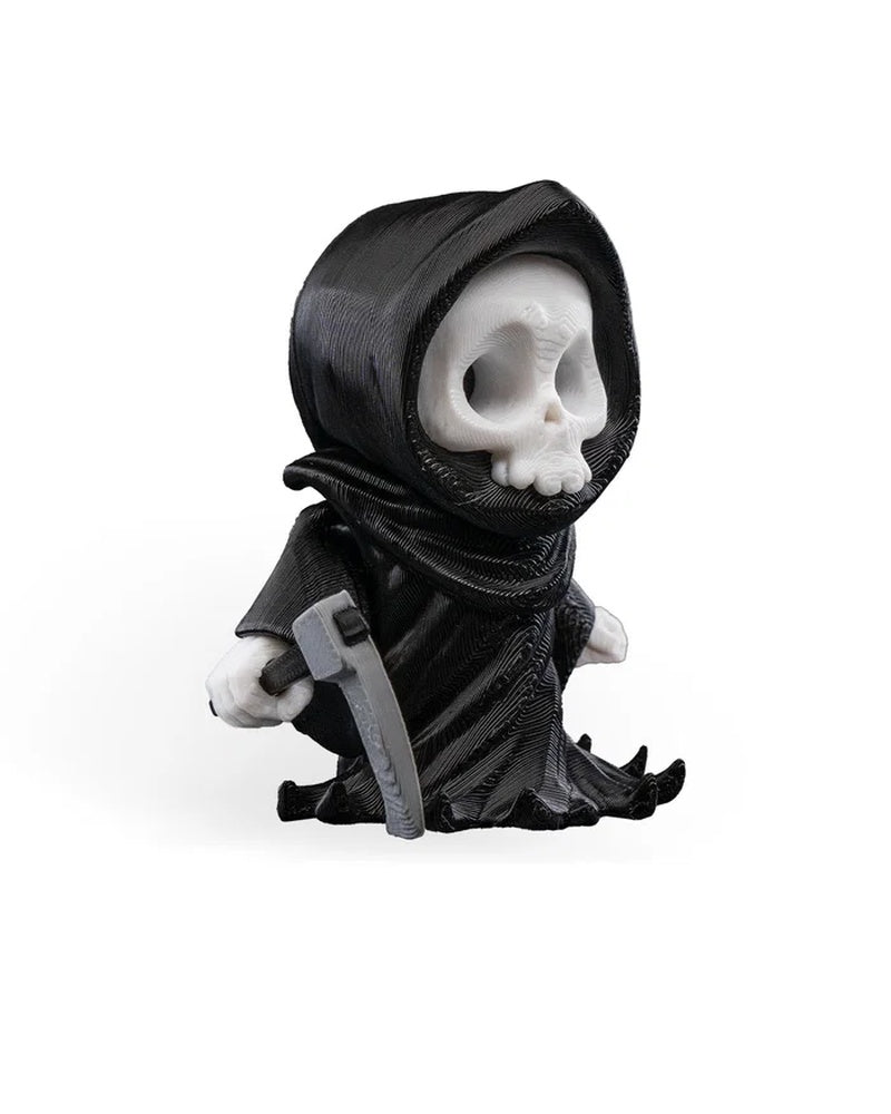 Angled side view of a black robed skull figure with a gray blade-like prop and white hands.