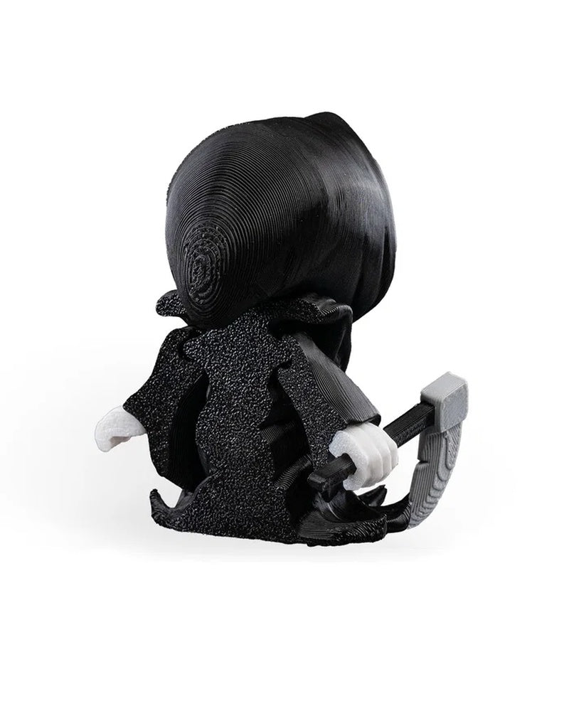 Rear angled view of a black hooded skull figure with white hands and a gray blade-like prop.