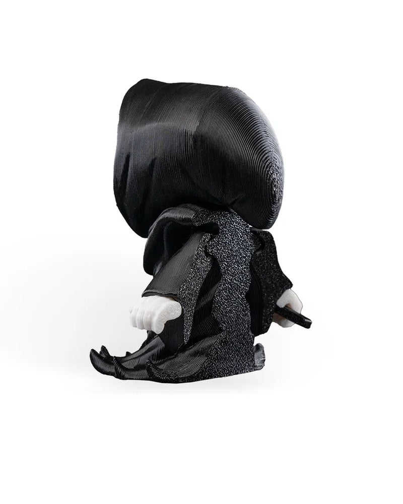 Back view of a black hooded robed figure with white hands and a small visible prop handle.