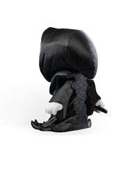 Back view of a black hooded robed figure with white hands and a small visible prop handle.