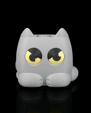 Gray cat-shaped planter with yellow-and-black eyes on a black background