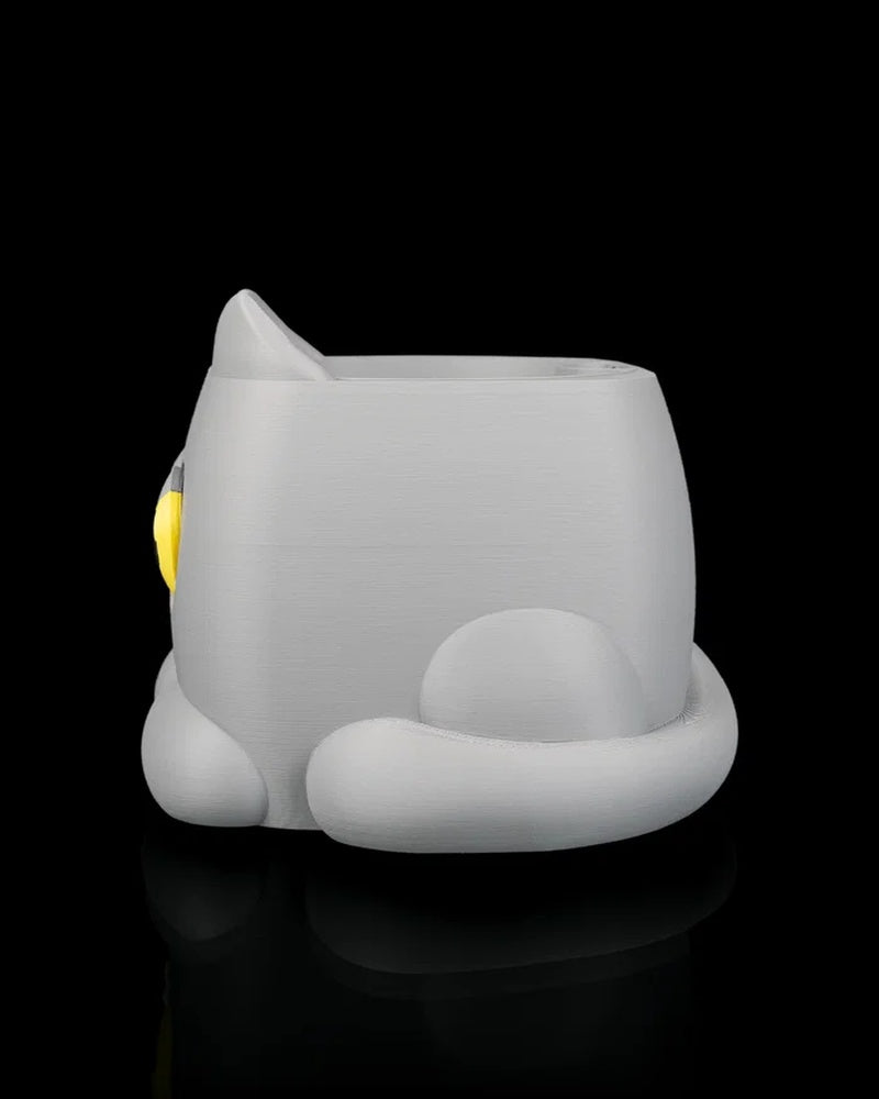 Side view of a gray cat-shaped planter with a curled tail on a black background