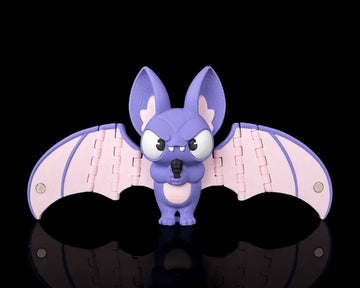 Purple bat figurine with pink wings spread wide on a black background