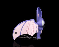 Side view of a purple and pink bat with a metal ring and chain beside it